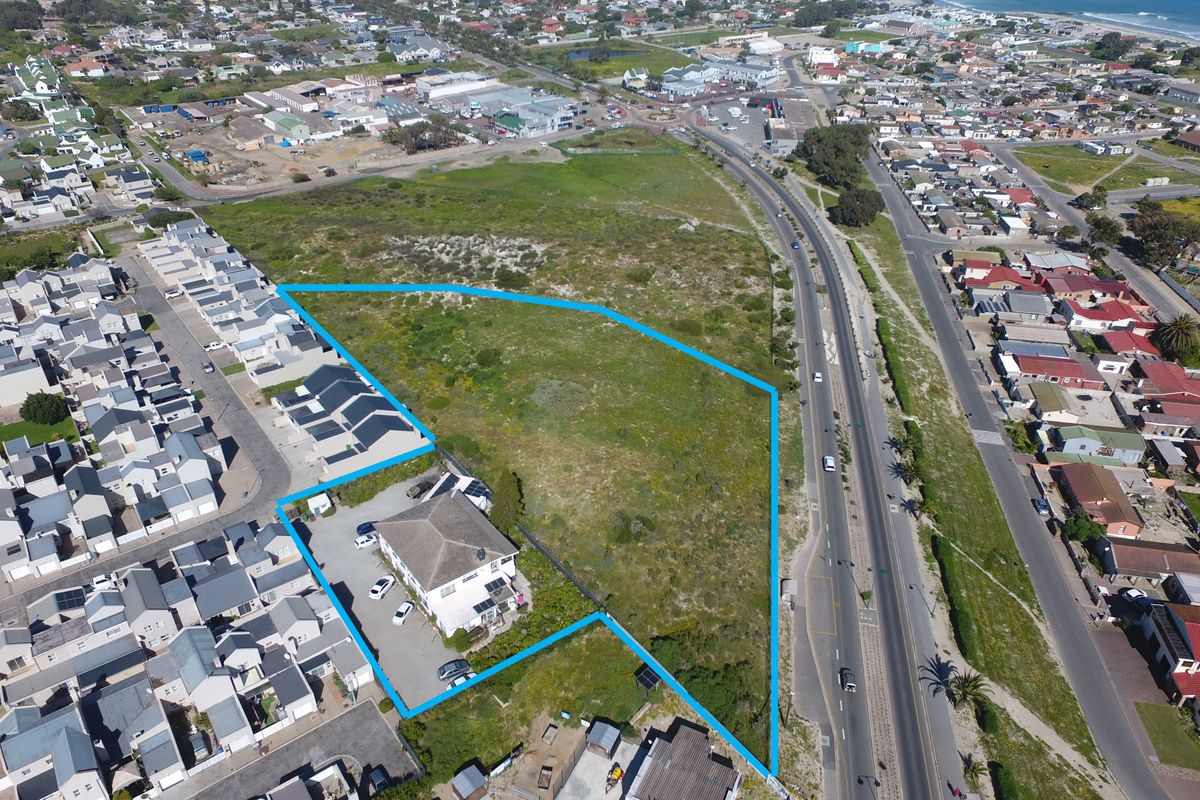 Aerial view of the property highlighting the plot boundaries, existing building structure, and surrounding residential neighborhood context.