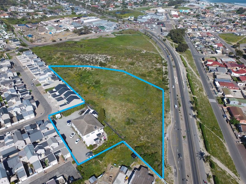 Aerial view of the property highlighting the plot boundaries, existing building structure, and surrounding residential neighborhood context.