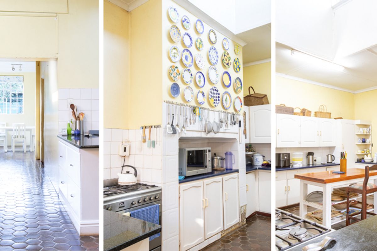 Spacious kitchen featuring gas stove, granite countertops, ample cabinetry, and a skylight, offering a functional layout with potential for modern updates.