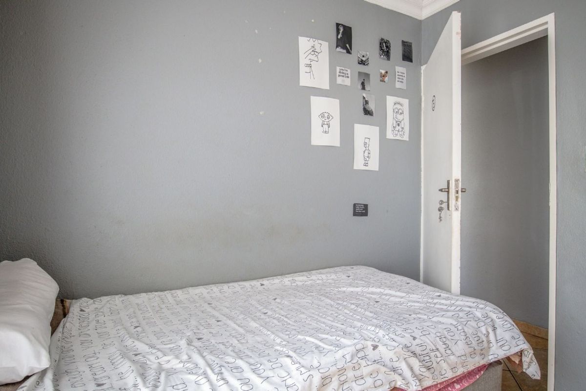 A standard bedroom featuring grey painted walls, coving, and a single internal door access.