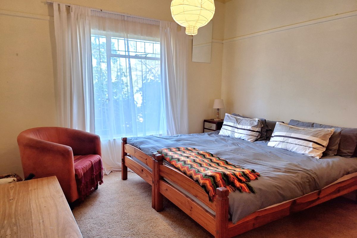 A bedroom featuring carpet flooring and a classic picture rail, offering a comfortable and functional living space.