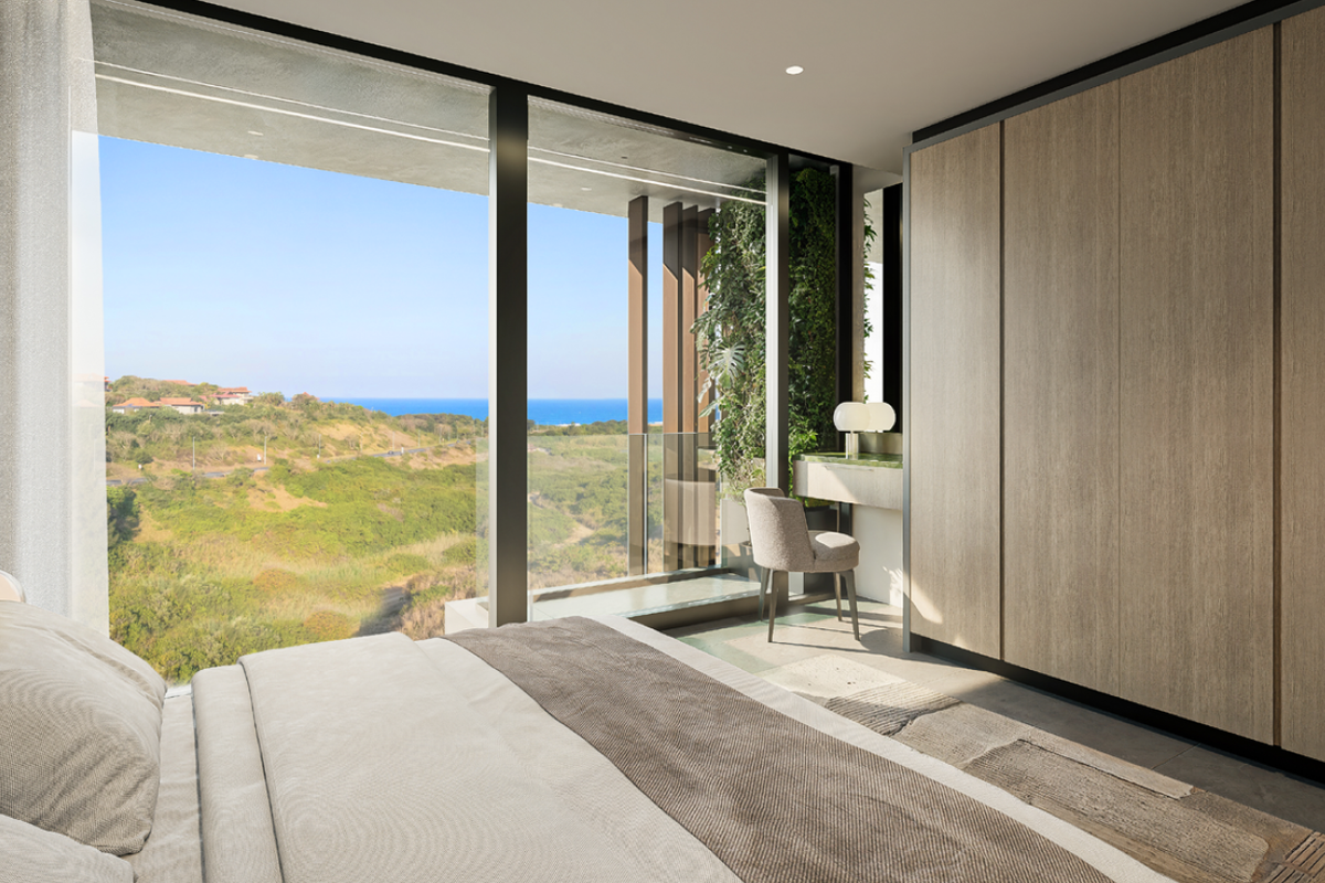 Modern bedroom featuring floor-to-ceiling windows with scenic coastal views, integrated floor-to-ceiling timber-look cabinetry, and a built-in vanity area.
