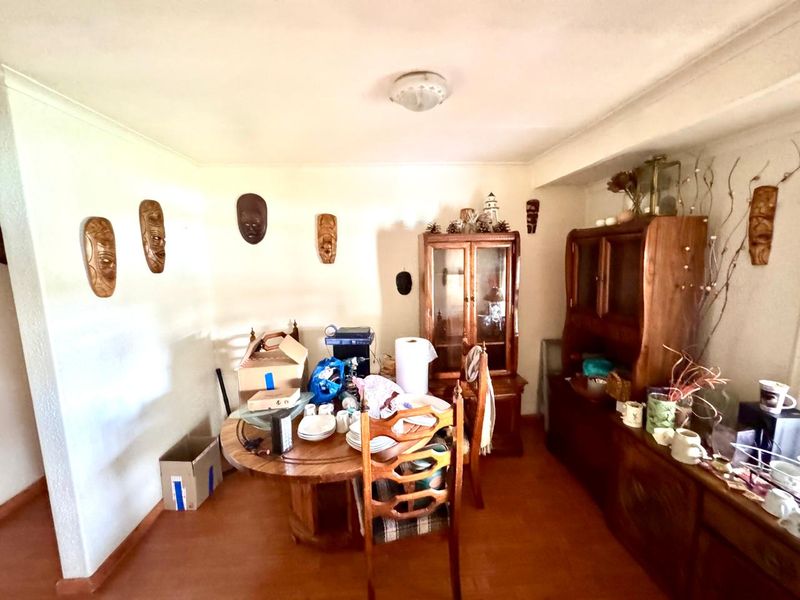 A dining room featuring tiled flooring and coved ceilings, providing a functional space for family meals.