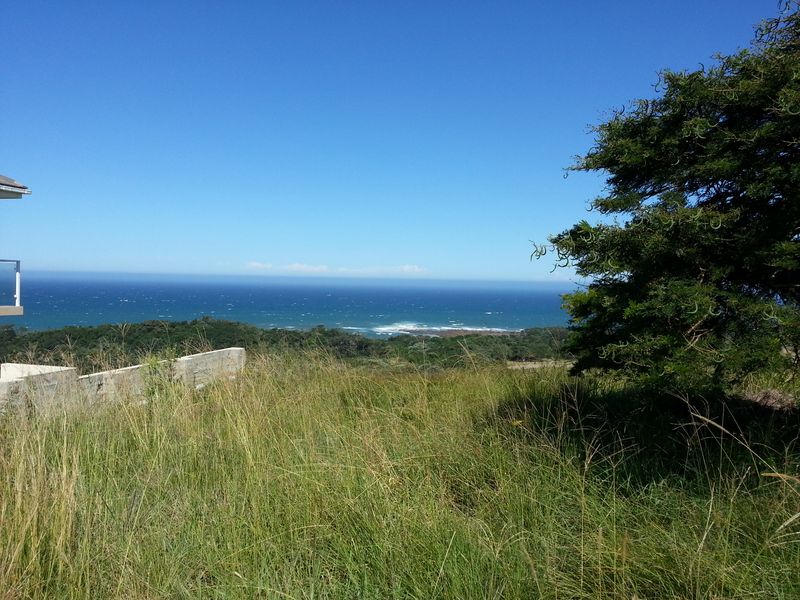 A scenic view overlooking the ocean and coastal landscape from the vacant residential property.