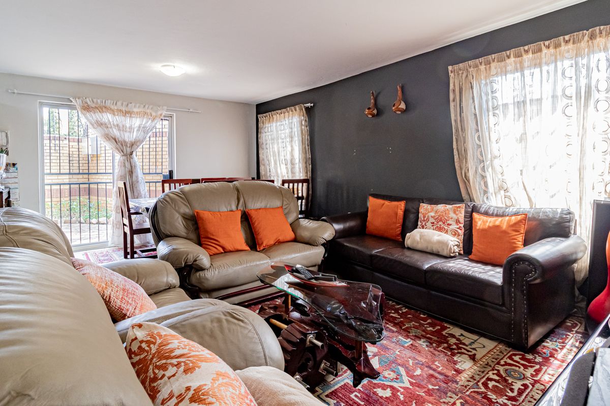 A comfortable living room featuring a sliding glass door that provides natural light and access to the outdoor area.