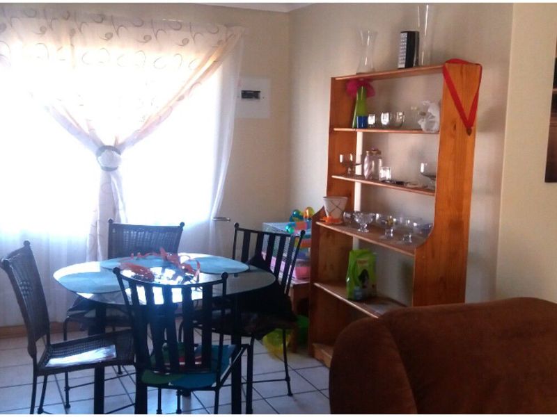 A functional dining area featuring tiled flooring and a neutral wall finish, providing a practical space for meals.