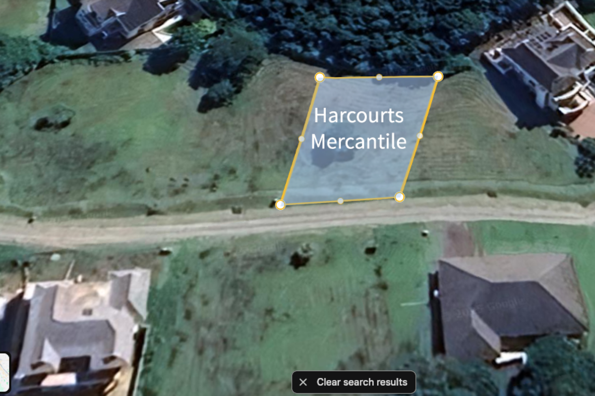 An aerial view showing the vacant residential land plot with surrounding established properties.