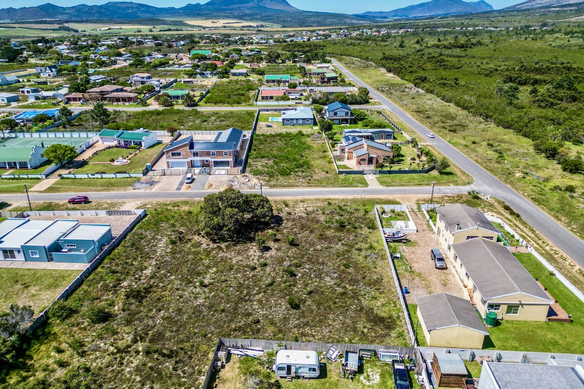 Aerial view of a vacant residential plot situated within an established neighborhood, offering clear boundaries and proximity to local infrastructure.