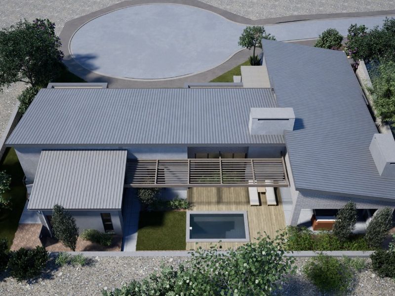 Aerial view of a modern residential property featuring a metal roof, swimming pool, timber deck, and pergola.