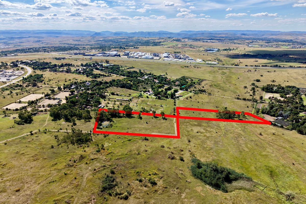 Aerial view of a large, undeveloped residential land parcel with clear boundary demarcations, set within a rural landscape.
