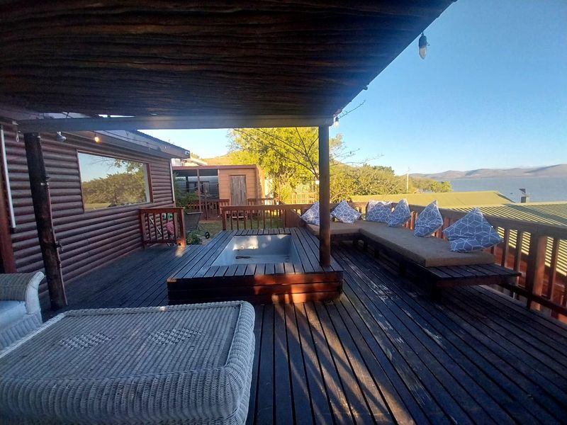 Spacious outdoor timber deck featuring a built-in sunken spa, covered patio area, and scenic views, perfect for outdoor relaxation and entertainment.
