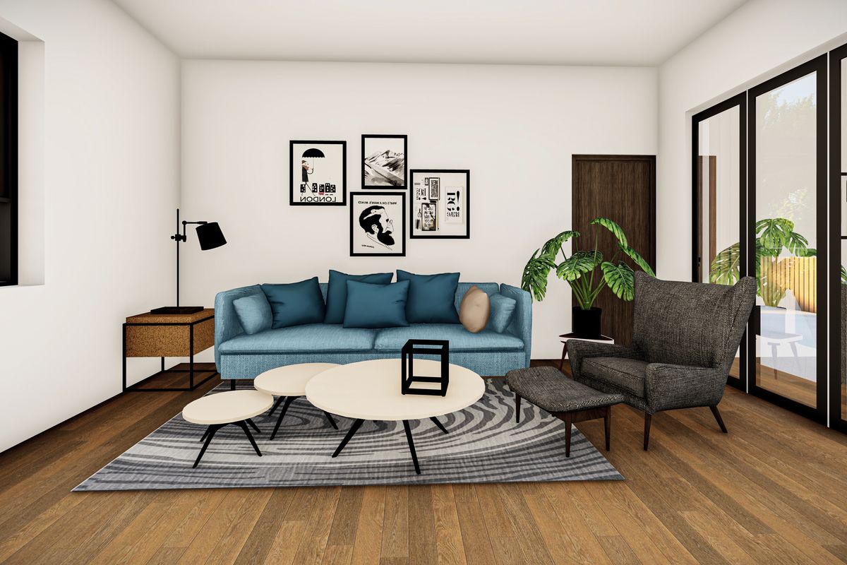 A modern living room featuring timber flooring and large black-framed sliding glass doors that provide ample natural light and access to the outdoors.
