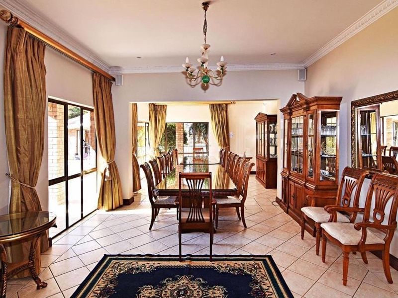 Spacious dining room featuring ceramic tile flooring, crown molding, and large sliding glass doors providing natural light and access to the exterior.