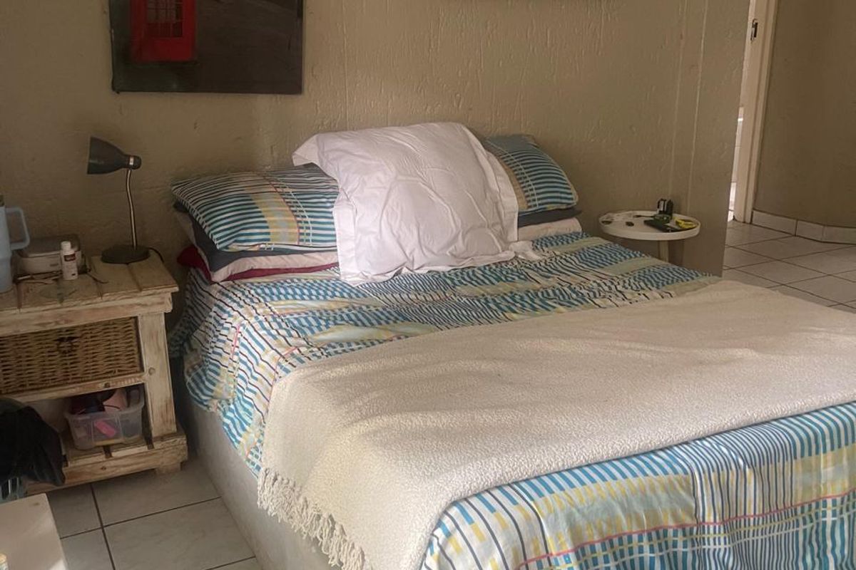 A bedroom featuring tiled flooring and neutral wall finishes, providing a functional space ready for personalization.