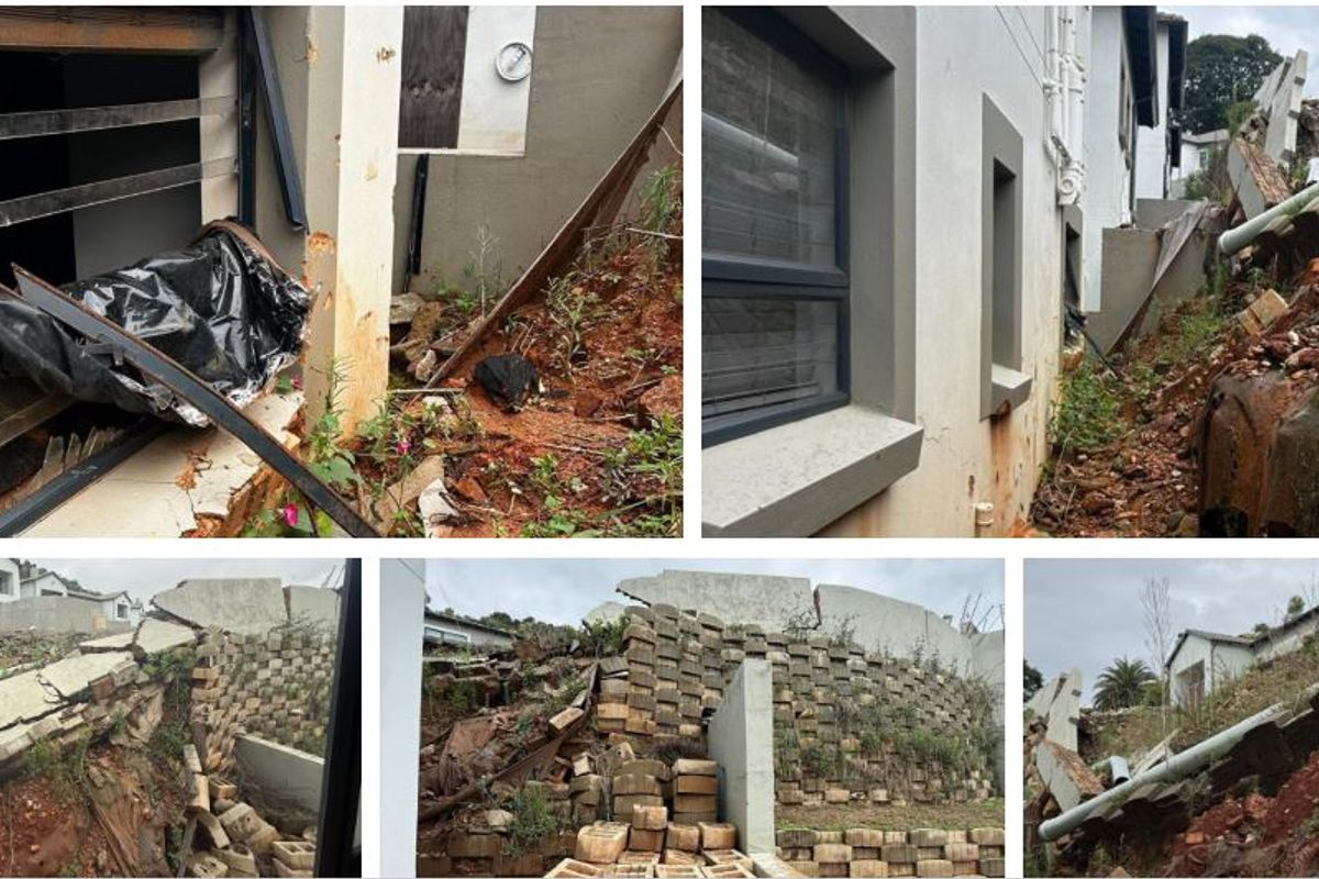 Exterior view showing significant structural damage to the retaining wall and surrounding garden area, indicating severe soil erosion and property infrastructure failure.