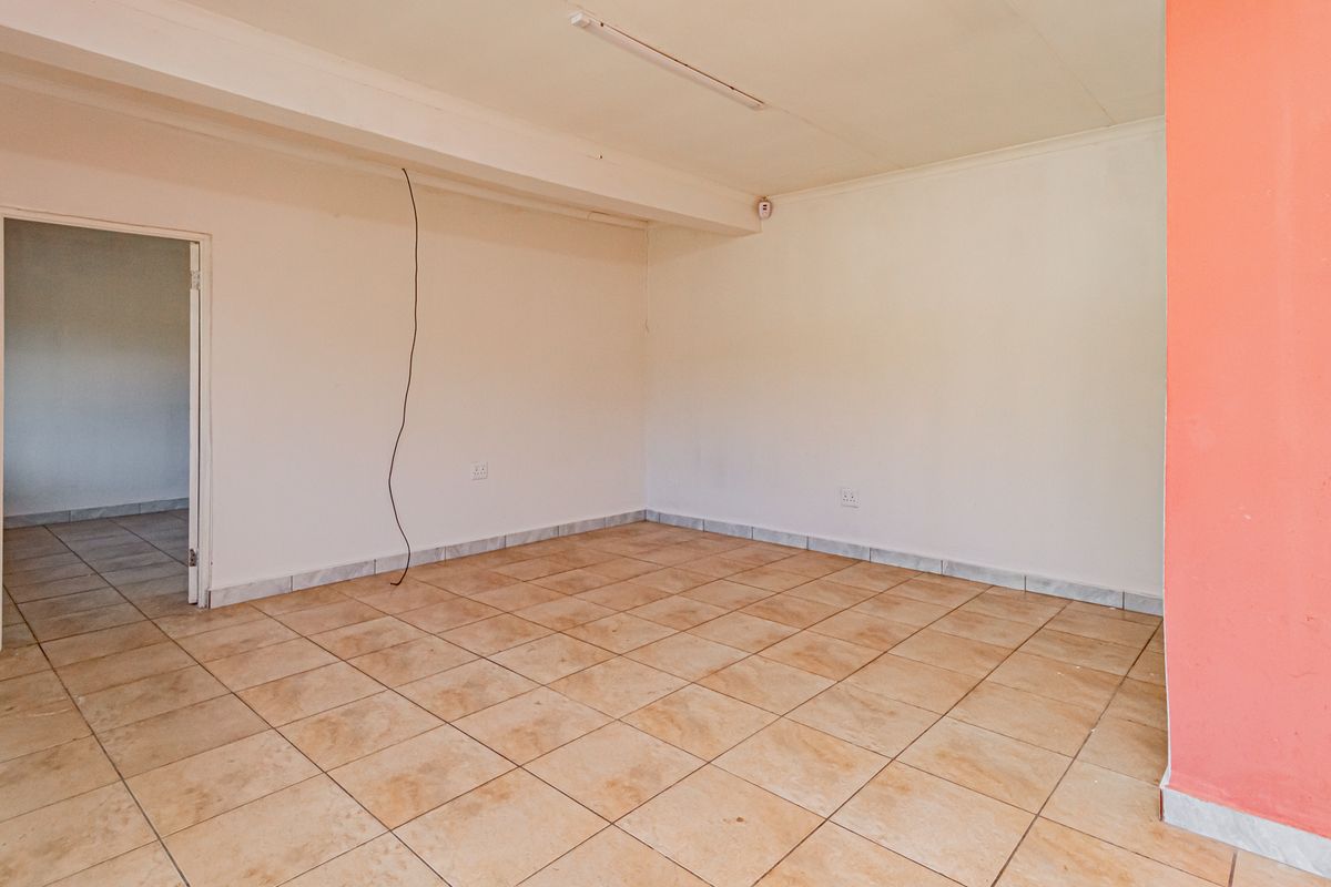 An empty living area featuring ceramic floor tiles and a neutral color palette, ready for personalization and staging.