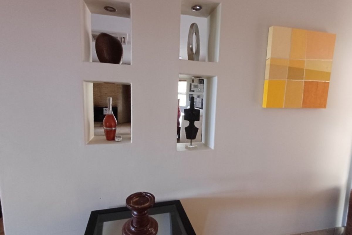 A feature wall with built-in recessed display niches and integrated downlighting, creating a modern architectural focal point within the living space.