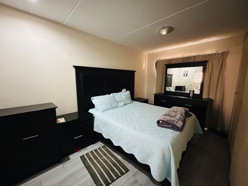 A standard bedroom featuring light-colored flooring and neutral wall finishes, providing a functional and comfortable sleeping space.