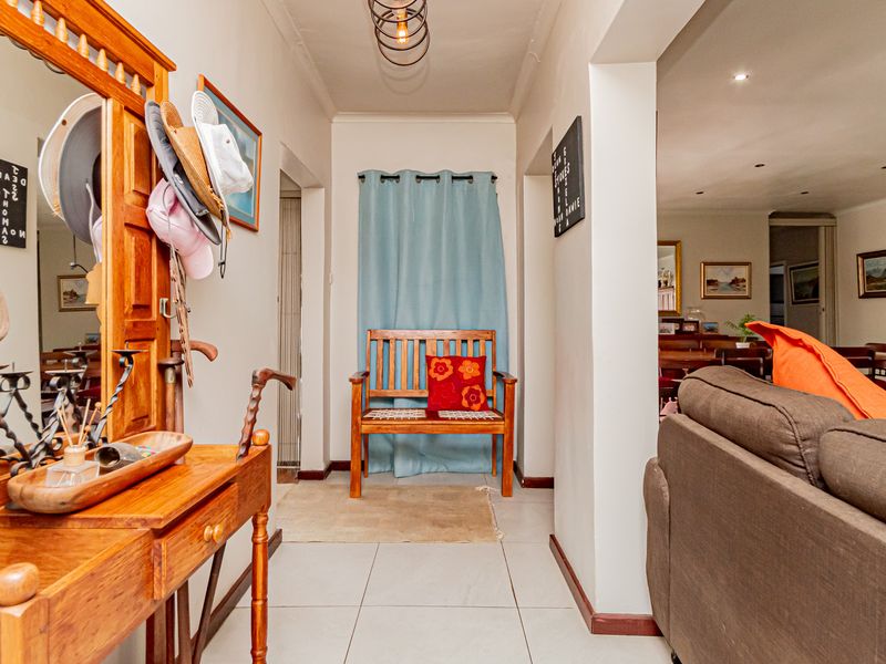 A functional hallway featuring tiled flooring and recessed lighting, providing a central transition space between the living area and other parts of the home.