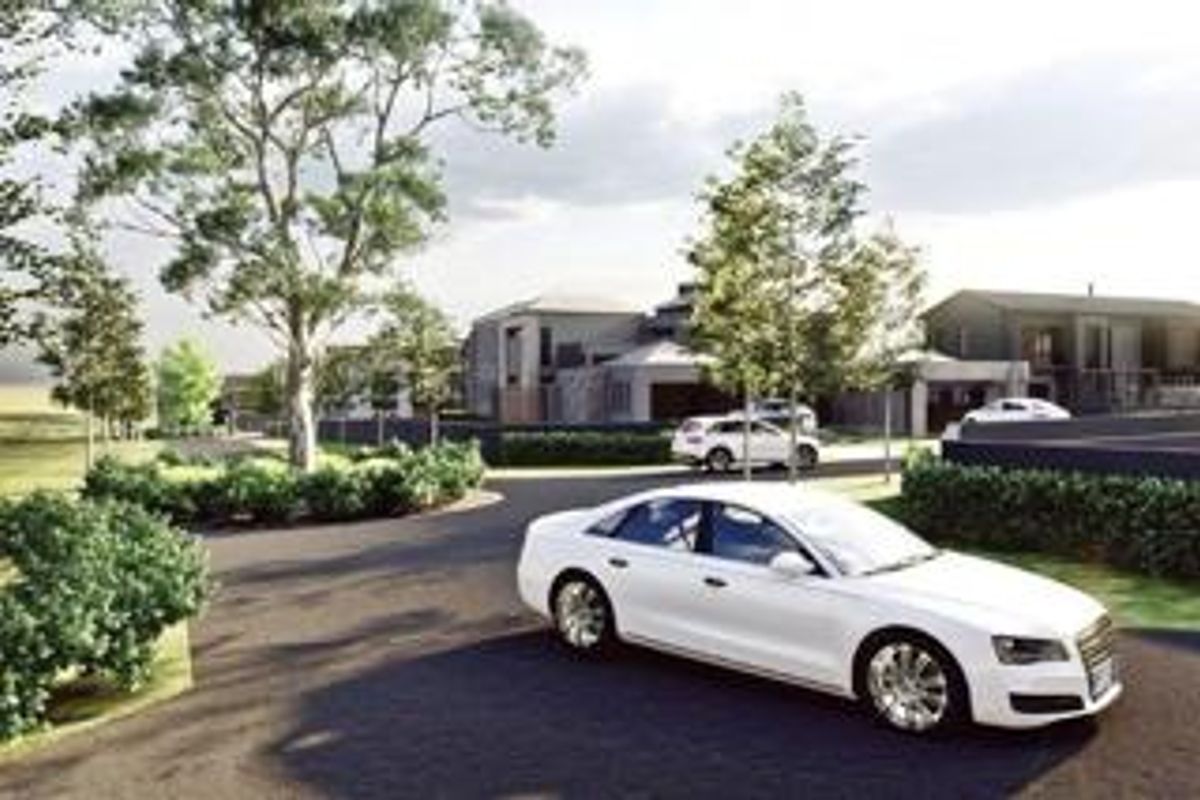 A perspective view of a residential estate entrance featuring paved roads, landscaped greenery, and modern architectural building designs.