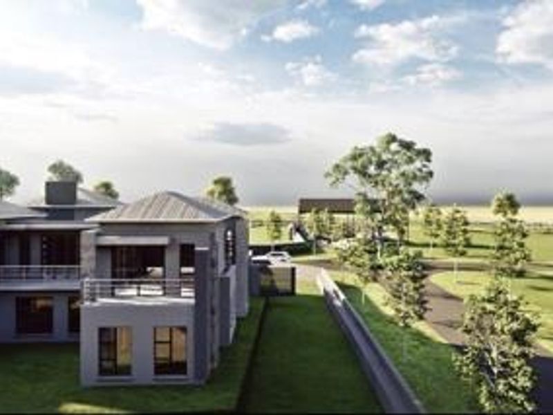 An aerial perspective of a modern residential property featuring expansive landscaped grounds, paved driveways, and a multi-level architectural design.