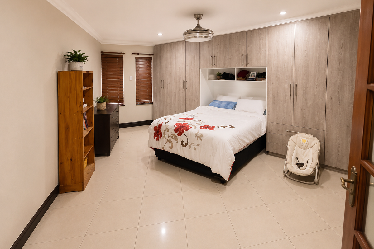 Spacious bedroom featuring extensive built-in cabinetry with integrated bed alcove, tiled flooring, recessed ceiling lighting, and wooden blinds.