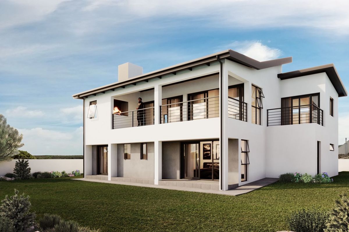 Rear view of a modern two-story house featuring a spacious upper balcony with a built-in braai and large sliding doors leading to the garden.