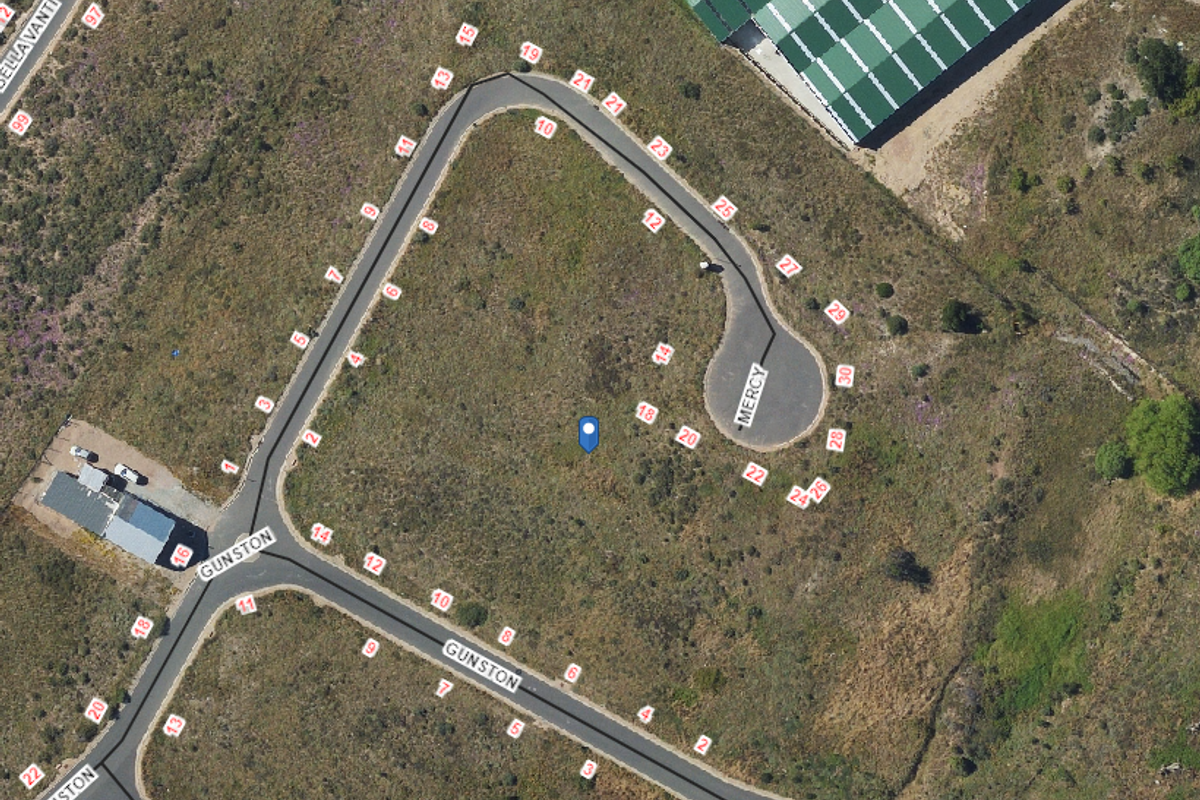 Aerial view of a vacant residential plot situated at the corner of Gunston and Mercy streets, featuring direct road access.
