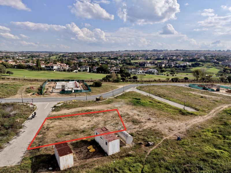 Aerial view of a vacant residential plot situated in a developed estate with surrounding golf course and suburban views.