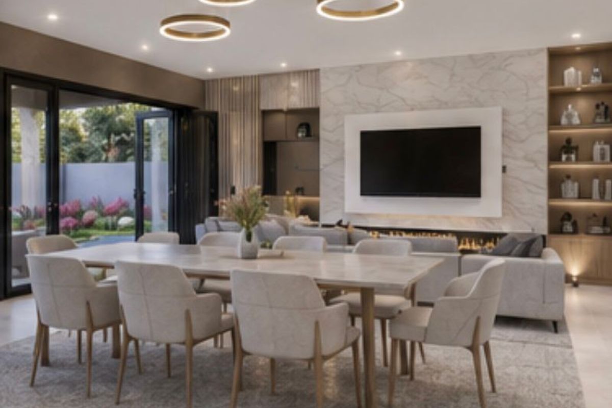 A modern open-plan living and dining area featuring a sleek built-in fireplace, marble-look feature wall, custom shelving, and seamless access to the outdoor patio.