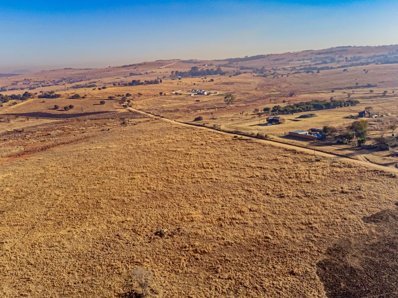 An aerial view of a large, expansive plot of vacant residential land in a rural setting.