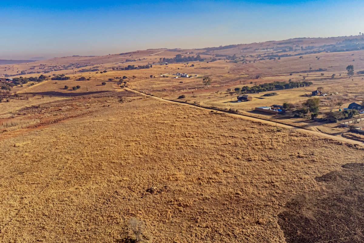 An aerial view of a large, expansive plot of vacant residential land in a rural setting.