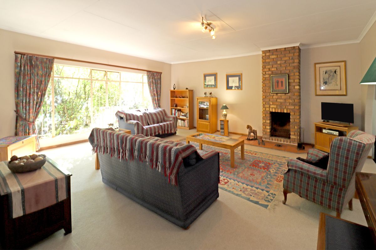 Spacious living room featuring a classic brick fireplace and a large sliding glass door that provides ample natural light.