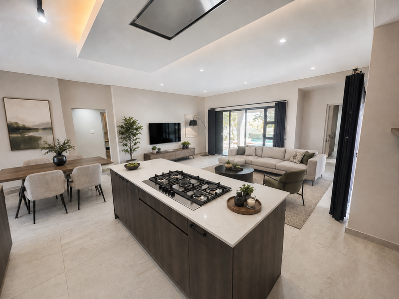 Spacious open-plan living area featuring a modern kitchen island with gas cooktop, recessed ceiling lighting, and seamless flow to the outdoor patio.
