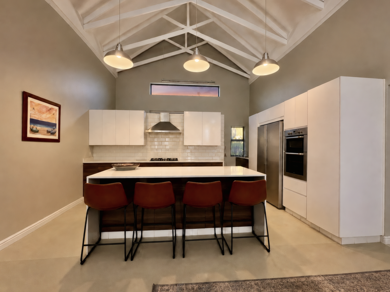 Modern kitchen featuring a high vaulted ceiling with exposed rafters, a central island, built-in appliances, and sleek white cabinetry with subway tile backsplash.