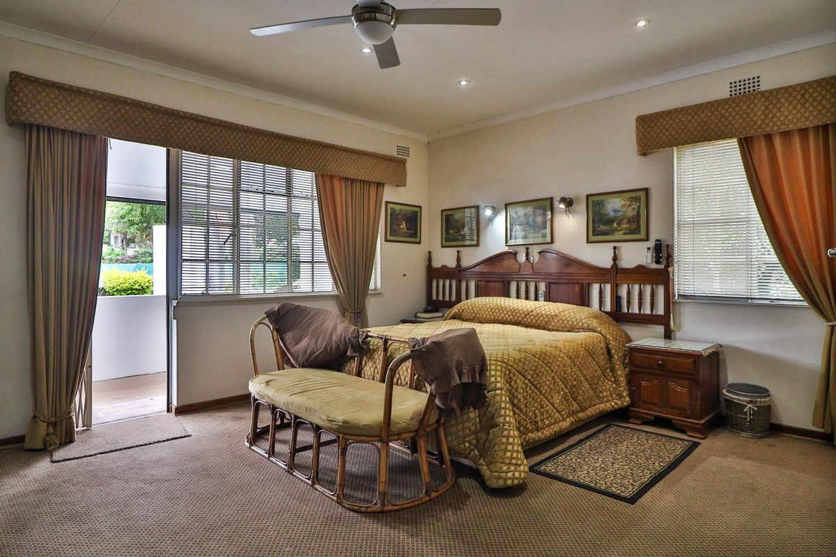 Spacious bedroom featuring carpeted flooring, a ceiling fan, recessed lighting, and direct access to an outdoor patio area through a sliding glass door.