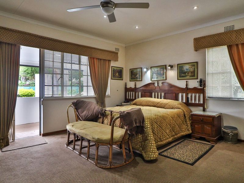 Spacious bedroom featuring carpeted flooring, a ceiling fan, recessed lighting, and direct access to an outdoor patio area through a sliding glass door.