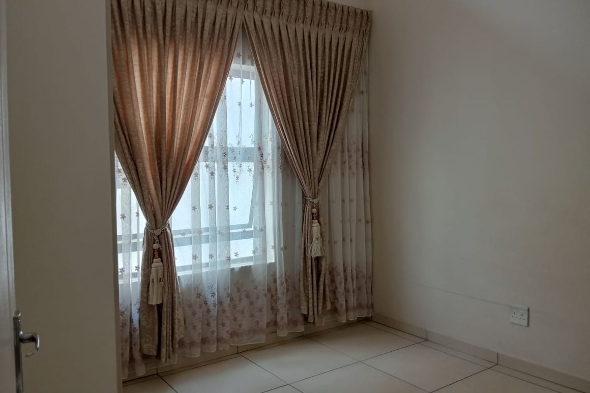 A bright, empty bedroom featuring neutral tiled flooring and large windows dressed with elegant floor-to-ceiling curtains.