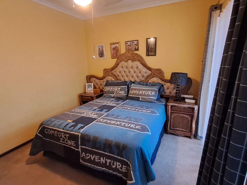 A standard bedroom featuring carpeted flooring and decorative coving, providing a functional space for rest.