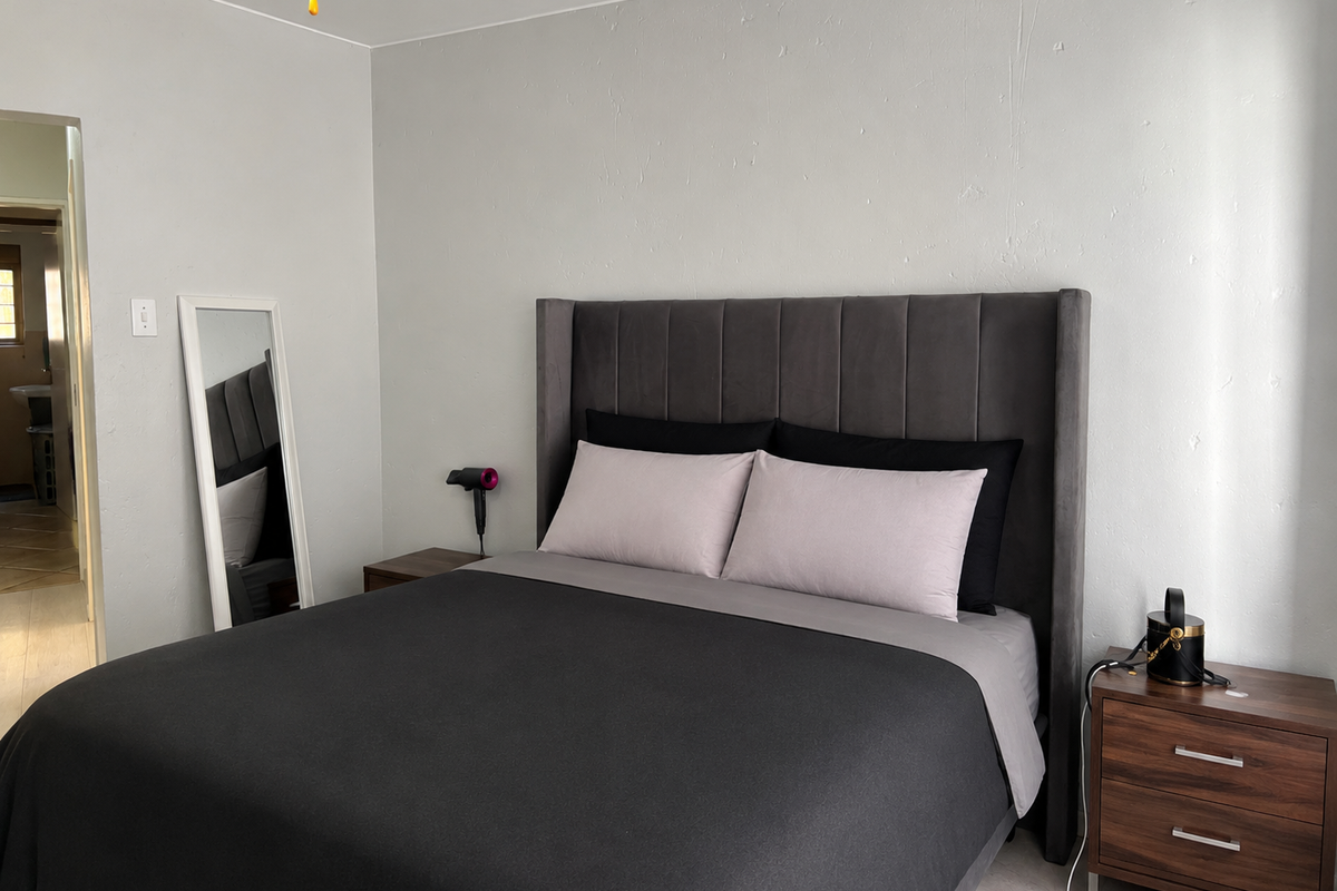 A well-maintained bedroom featuring neutral wall finishes and a clean, functional layout.