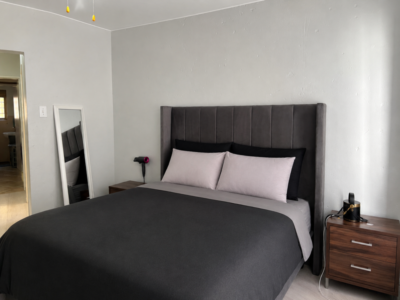 A well-maintained bedroom featuring neutral wall finishes and a clean, functional layout.