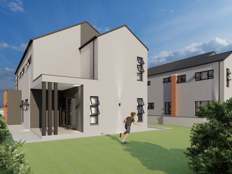 A modern two-story residential property featuring a clean plastered facade, pitched roof, and a covered patio area overlooking a private garden.