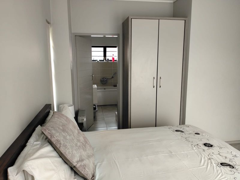 A well-maintained bedroom featuring a built-in wardrobe and direct access to an en-suite bathroom.