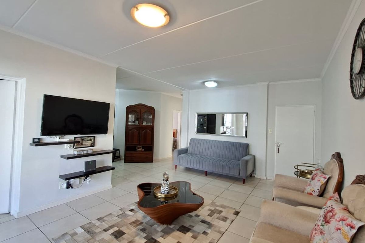 A spacious living room featuring neutral tiled flooring and bright white walls, providing a clean and versatile foundation for your personal style.