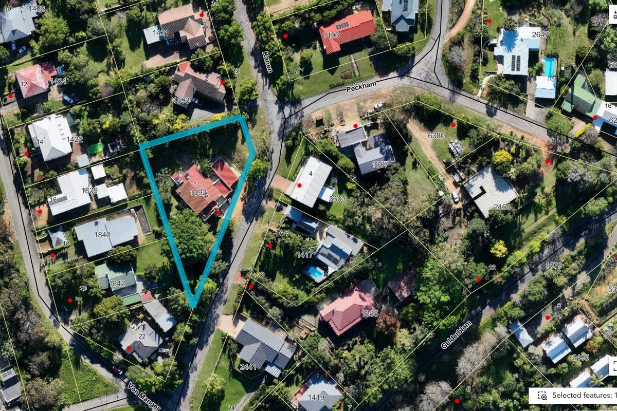 An aerial view of the property highlighting the residential plot, roof structure, and surrounding garden area within the neighborhood.