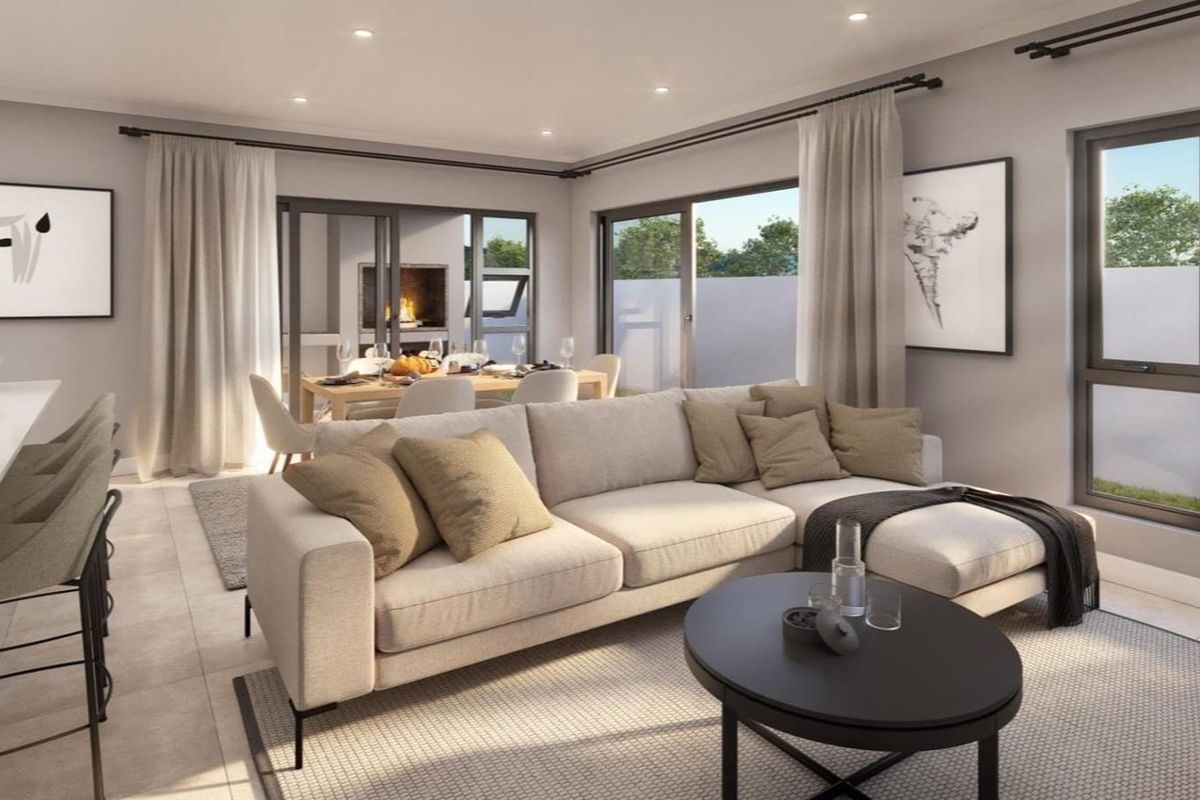 Modern open-plan living area featuring tiled floors, recessed lighting, and large sliding glass doors providing seamless access to the outdoor patio space.