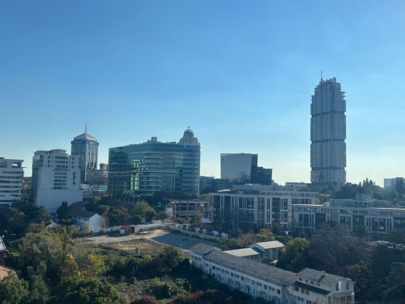 An elevated urban cityscape view showcasing surrounding high-rise buildings and residential developments.