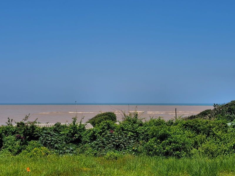 A scenic view of the ocean horizon from the property, showcasing the natural coastal landscape and open water.