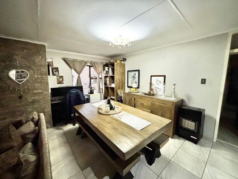 A living area featuring tiled flooring and a prominent stone feature wall, providing a textured focal point within the room.