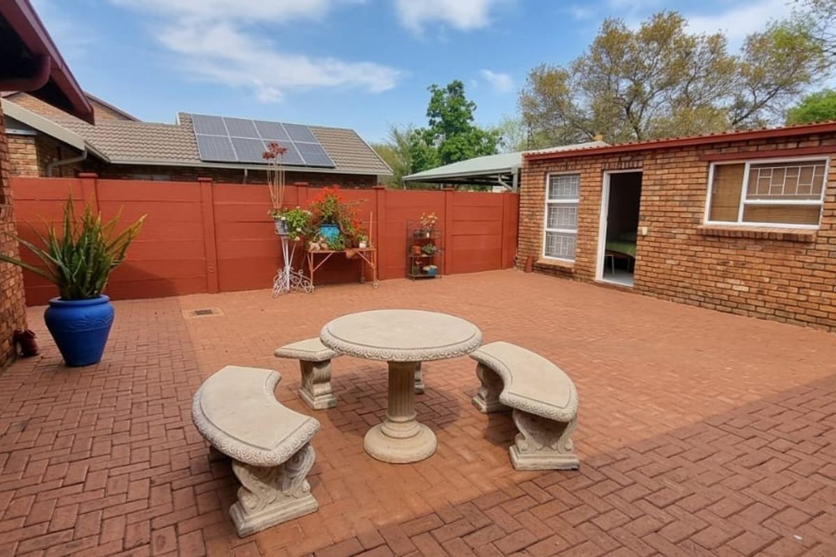 A private rear courtyard featuring durable brick paving, facebrick exterior walls, and a secure boundary wall, providing a low-maintenance outdoor living space.